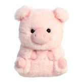 A pink pig plush toy from the Rolly Pet collection by Aurora with a round body and a playful expression